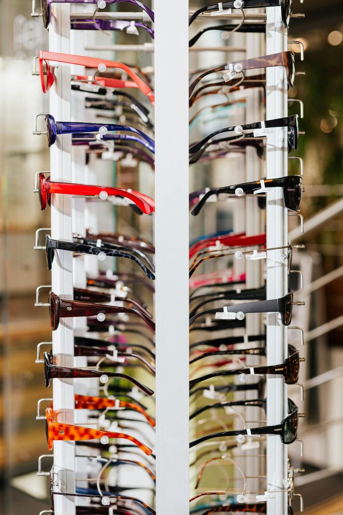 Branzs Eyewear Vibrant array of eyeglasses on a display rack in a modern optical store.